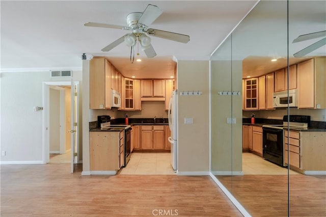 1620 Neil Armstrong St Unit 306, Montebello, CA 90640 - kitchen with black electric range, electric range, white microwave, dark countertops, and recessed lighting