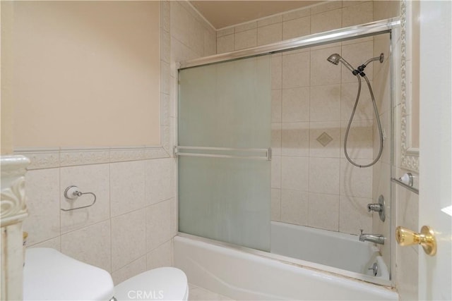 1620 Neil Armstrong St Unit 306, Montebello, CA 90640 - full bath with combined bath / shower with glass door, tile walls, and a wainscoted wall
