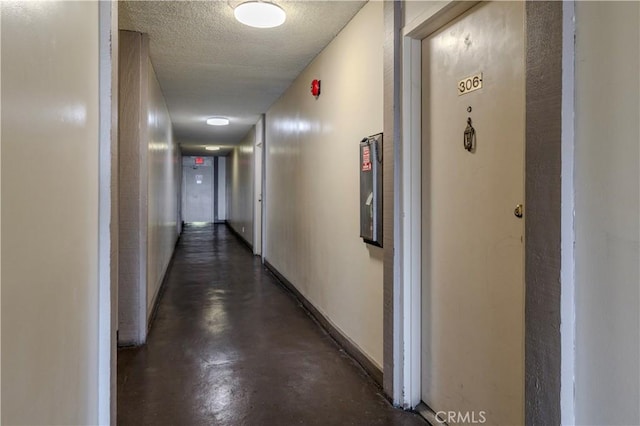 1620 Neil Armstrong St Unit 306, Montebello, CA 90640 - corridor featuring concrete floors and a textured ceiling