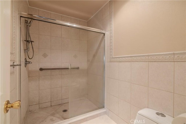 1620 Neil Armstrong St Unit 306, Montebello, CA 90640 - bathroom featuring a stall shower and tile walls