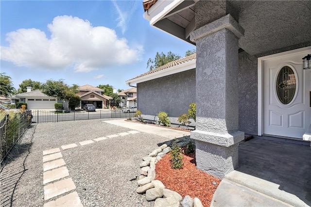 10655 Springfield Dr, Rancho Cucamonga, CA 91730 - doorway to property featuring stucco siding and a residential view