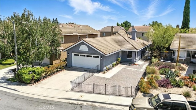 10655 Springfield Dr, Rancho Cucamonga, CA 91730 - view of front of house featuring a tiled roof, a fenced front yard, a garage, stucco siding, and driveway