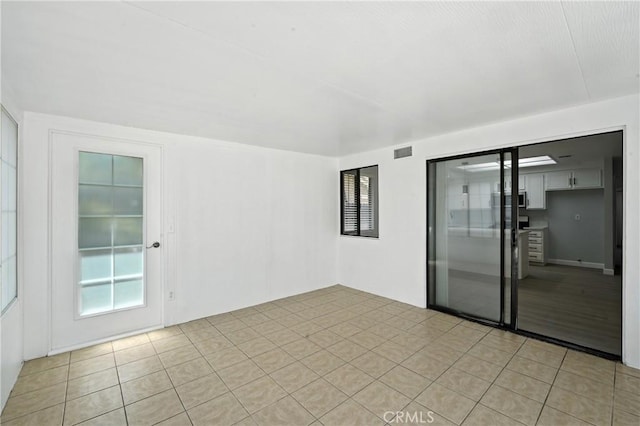 10655 Springfield Dr, Rancho Cucamonga, CA 91730 - spare room featuring light tile patterned floors and plenty of natural light
