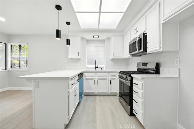 10655 Springfield Dr, Rancho Cucamonga, CA 91730 - kitchen with stainless steel appliances, light wood-style floors, a peninsula, white cabinets, and light countertops