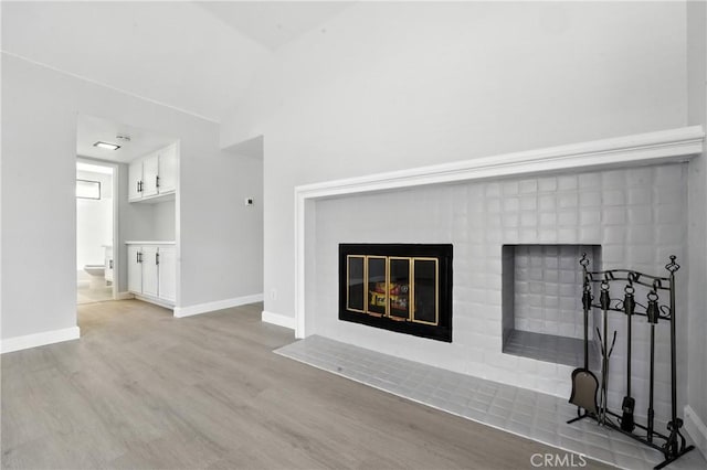 10655 Springfield Dr, Rancho Cucamonga, CA 91730 - unfurnished living room with a fireplace with flush hearth, wood finished floors, and vaulted ceiling