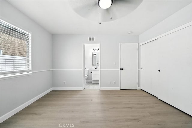 10655 Springfield Dr, Rancho Cucamonga, CA 91730 - unfurnished bedroom featuring wood finished floors, connected bathroom, a closet, and a ceiling fan