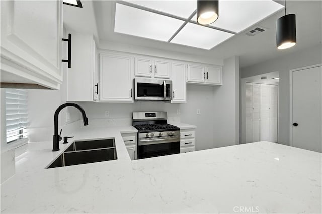 10655 Springfield Dr, Rancho Cucamonga, CA 91730 - kitchen with stainless steel appliances, light stone countertops, white cabinets, and pendant lighting