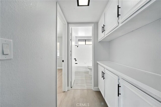 10655 Springfield Dr, Rancho Cucamonga, CA 91730 - hall with light wood-style floors and a textured wall