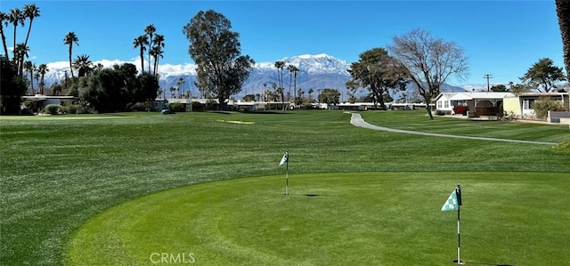 32540 San Miguelito Dr, Thousand Palms, CA 92276 - surrounding community featuring view of golf course, a putting area, a mountain view, and a lawn