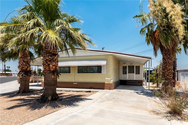 32540 San Miguelito Dr, Thousand Palms, CA 92276 - manufactured / mobile home with driveway, a carport, entry steps, and crawl space