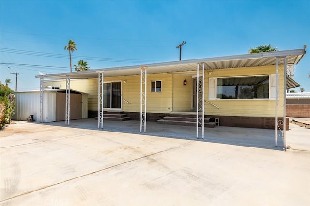 32540 San Miguelito Dr, Thousand Palms, CA 92276 - manufactured / mobile home featuring entry steps and a storage unit