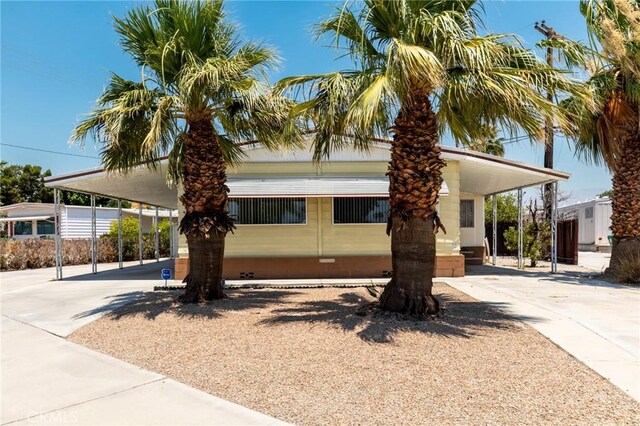 32540 San Miguelito Dr, Thousand Palms, CA 92276 - manufactured / mobile home with concrete driveway, crawl space, and an attached carport