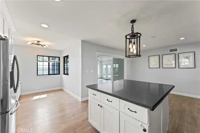 19408 Campaign Dr, Carson, CA 90746 - kitchen with stainless steel fridge, dark countertops, recessed lighting, light wood-style floors, and white cabinets