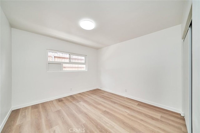1103 S Hobart Blvd, Los Angeles, CA 90006 - spare room featuring light wood-type flooring and baseboards