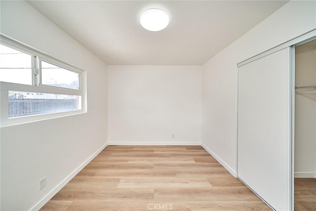 1103 S Hobart Blvd, Los Angeles, CA 90006 - unfurnished bedroom featuring a closet and light wood-type flooring