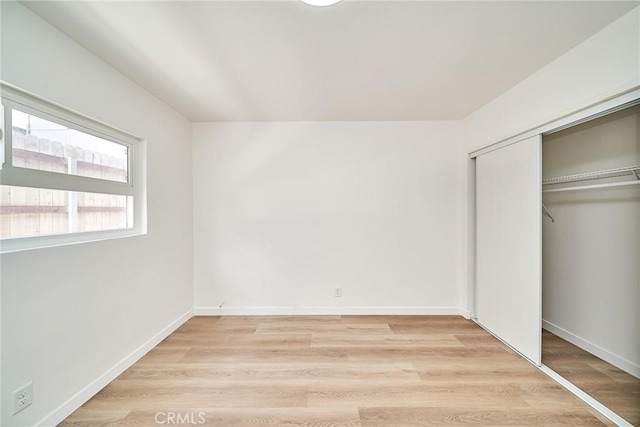 1103 S Hobart Blvd, Los Angeles, CA 90006 - unfurnished bedroom featuring light wood finished floors and a closet
