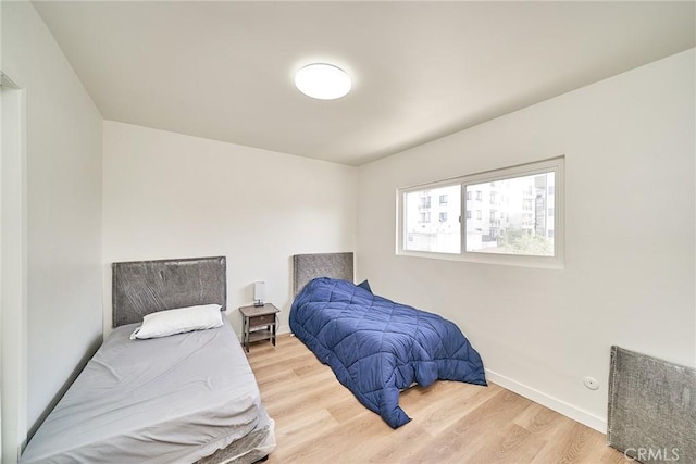 1103 S Hobart Blvd, Los Angeles, CA 90006 - bedroom with light wood-style floors and baseboards