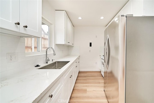 1103 S Hobart Blvd, Los Angeles, CA 90006 - kitchen with freestanding refrigerator, white cabinetry, backsplash, light wood-type flooring, and recessed lighting