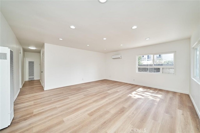 1103 S Hobart Blvd, Los Angeles, CA 90006 - unfurnished room with a heating unit, an AC wall unit, light wood-type flooring, and recessed lighting