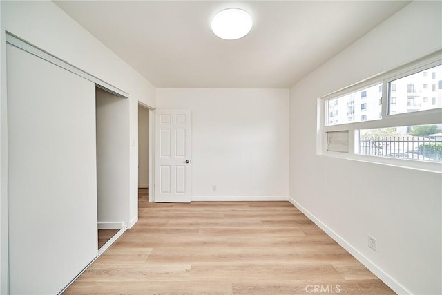 1103 S Hobart Blvd, Los Angeles, CA 90006 - unfurnished bedroom with baseboards and light wood-type flooring