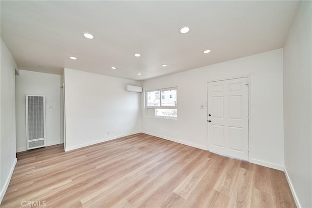 1103 S Hobart Blvd, Los Angeles, CA 90006 - empty room with a heating unit, a wall unit AC, light wood-style floors, and recessed lighting