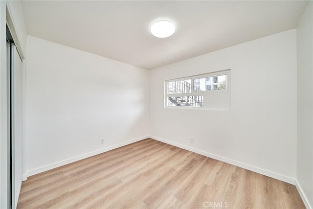1103 S Hobart Blvd, Los Angeles, CA 90006 - spare room with light wood-type flooring and baseboards
