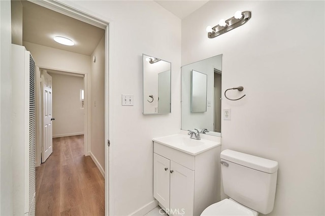 1103 S Hobart Blvd, Los Angeles, CA 90006 - bathroom featuring a heating unit, vanity, and wood finished floors