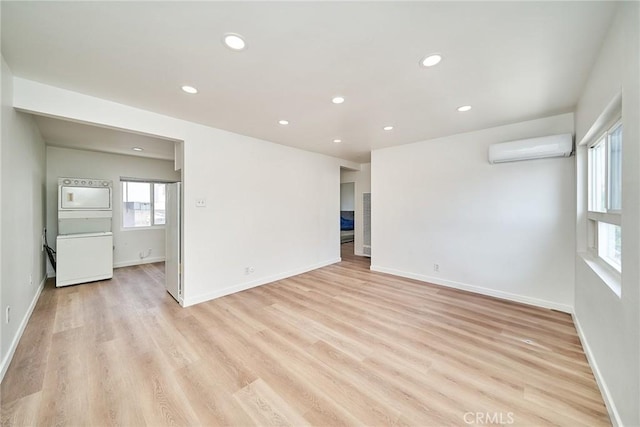 1103 S Hobart Blvd, Los Angeles, CA 90006 - unfurnished room with a wall unit AC, recessed lighting, and light wood finished floors