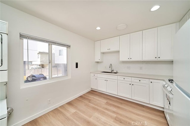1103 S Hobart Blvd, Los Angeles, CA 90006 - kitchen with gas range gas stove, white cabinets, light countertops, tasteful backsplash, and light wood-type flooring