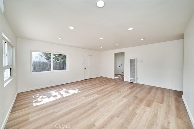 1103 S Hobart Blvd, Los Angeles, CA 90006 - empty room featuring a heating unit, healthy amount of natural light, light wood-style flooring, and recessed lighting