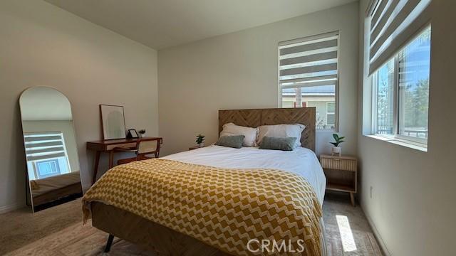 265 N Standard Ave, Santa Ana, CA 92701 - carpeted bedroom featuring arched walkways and baseboards