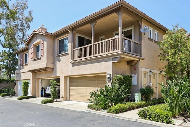 15 Ardmore, Irvine, CA 92602 - townhome / multi-family property featuring a balcony, a chimney, stucco siding, and a garage