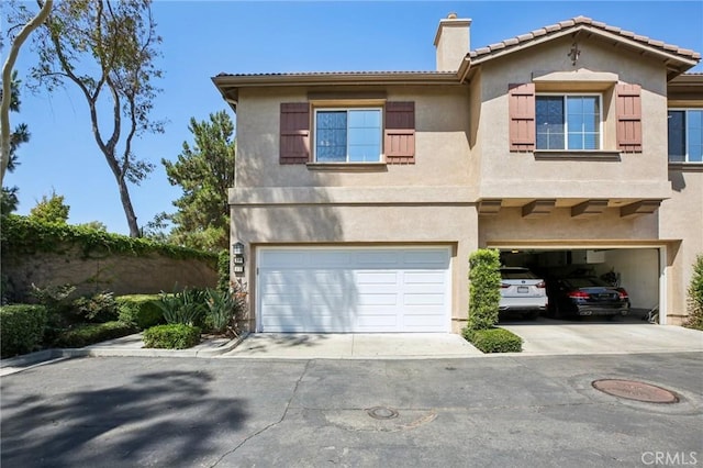 15 Ardmore, Irvine, CA 92602 - view of front of property with a garage, a chimney, and stucco siding