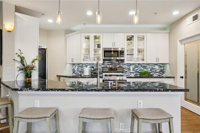 15 Ardmore, Irvine, CA 92602 - kitchen with appliances with stainless steel finishes, decorative backsplash, white cabinets, decorative light fixtures, and recessed lighting