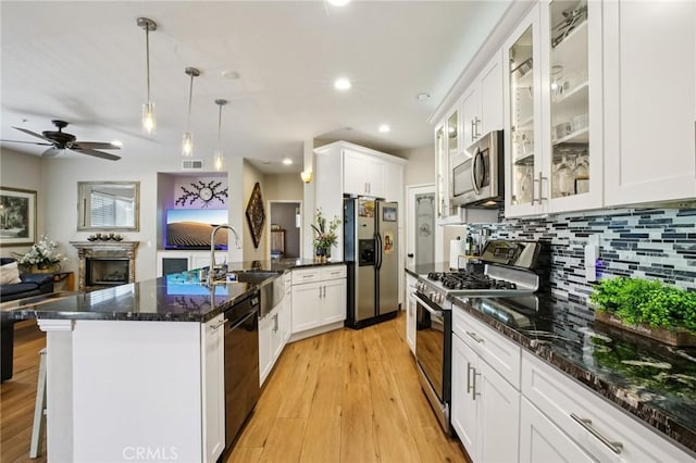 15 Ardmore, Irvine, CA 92602 - kitchen with appliances with stainless steel finishes, a peninsula, open floor plan, white cabinetry, and backsplash