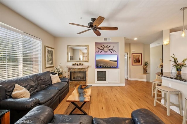 15 Ardmore, Irvine, CA 92602 - living room with ceiling fan, a fireplace, and light wood-type flooring