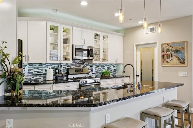 15 Ardmore, Irvine, CA 92602 - kitchen featuring stainless steel appliances, tasteful backsplash, white cabinets, hanging light fixtures, and recessed lighting
