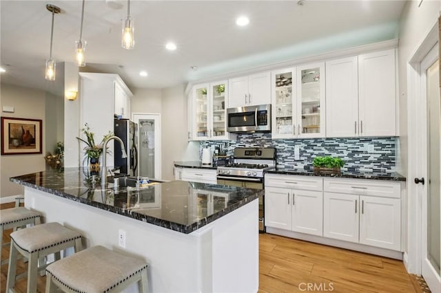 15 Ardmore, Irvine, CA 92602 - kitchen with stainless steel appliances, a breakfast bar area, backsplash, white cabinetry, and recessed lighting
