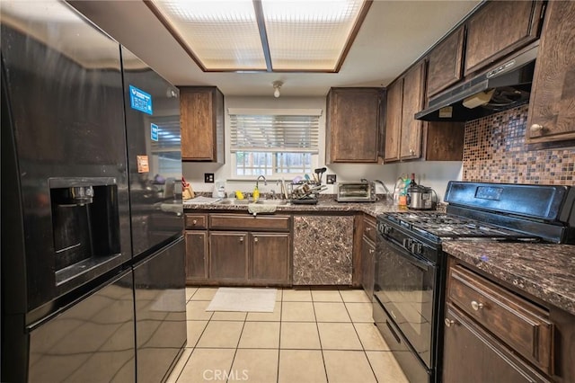 8936 Summerwood Way, Fontana, CA 92335 - kitchen with black appliances, under cabinet range hood, light tile patterned floors, backsplash, and dark brown cabinets
