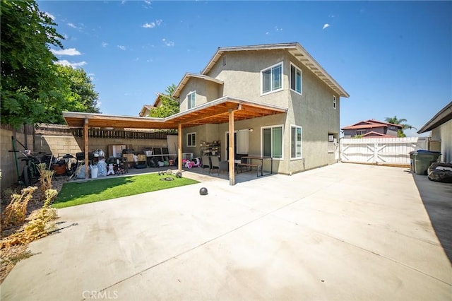 8936 Summerwood Way, Fontana, CA 92335 - back of property with stucco siding, a patio area, and a fenced backyard