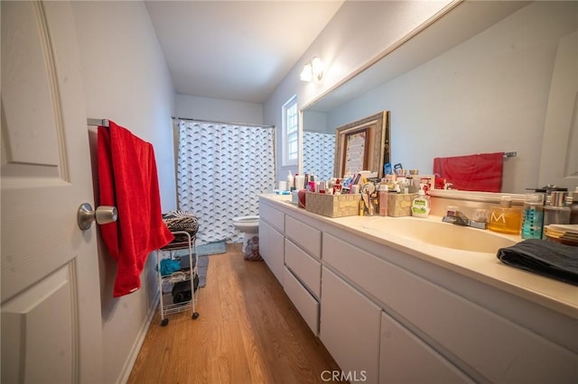 8936 Summerwood Way, Fontana, CA 92335 - full bathroom with wood finished floors, vanity, and a shower with curtain