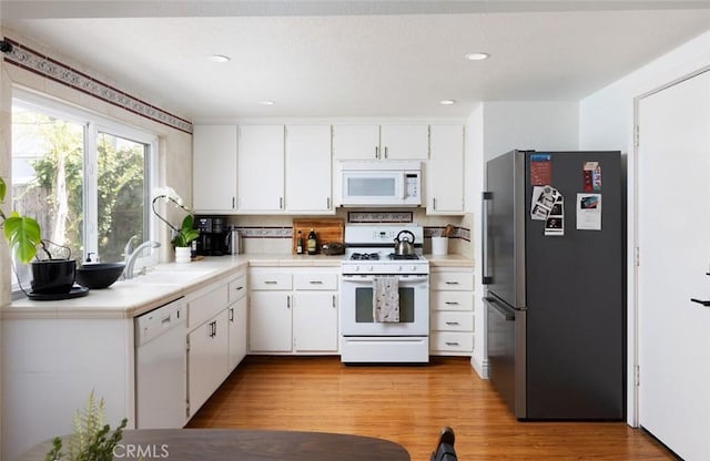 26645 Paseo Ensenada, San Juan Capistrano, CA 92675 - kitchen featuring white appliances, white cabinetry, tasteful backsplash, light wood finished floors, and recessed lighting
