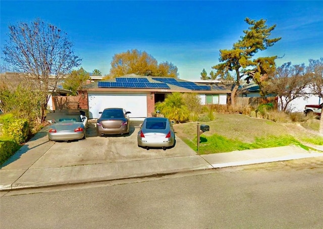 534 Francis St, Bakersfield, CA 93308 - view of front of house with solar panels, an attached garage, a front yard, and driveway