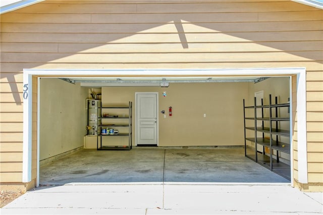 3591 Sacramento Dr Unit 50, San Luis Obispo, CA 93401 - garage featuring strapped water heater and concrete driveway