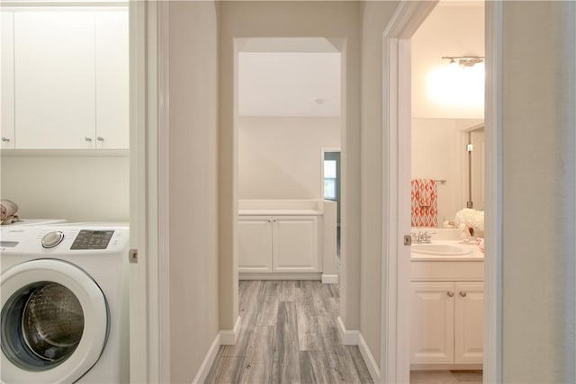 3591 Sacramento Dr Unit 50, San Luis Obispo, CA 93401 - laundry room with washer / clothes dryer, cabinet space, and light wood-style floors
