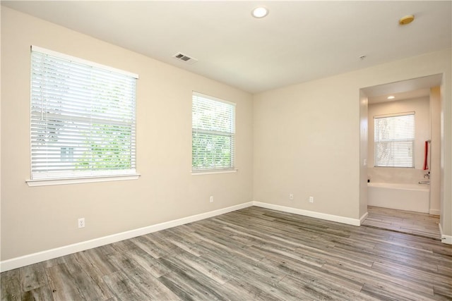 3591 Sacramento Dr Unit 50, San Luis Obispo, CA 93401 - empty room with wood finished floors, healthy amount of natural light, a smoke detector, and recessed lighting