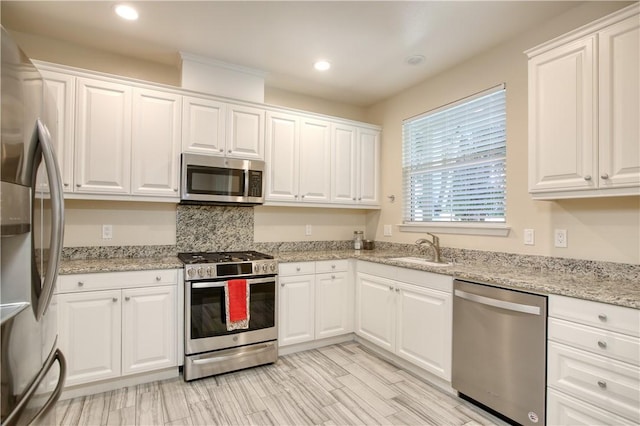 3591 Sacramento Dr Unit 50, San Luis Obispo, CA 93401 - kitchen with appliances with stainless steel finishes, white cabinetry, recessed lighting, and light stone counters
