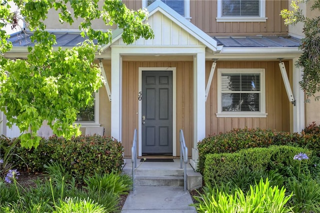 3591 Sacramento Dr Unit 50, San Luis Obispo, CA 93401 - doorway to property with board and batten siding, a standing seam roof, and a metal roof