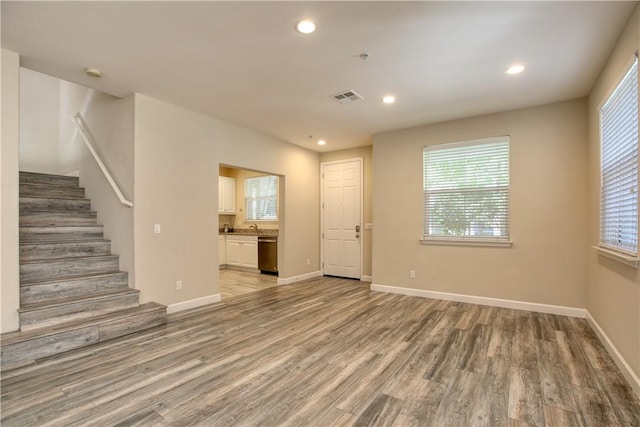 3591 Sacramento Dr Unit 50, San Luis Obispo, CA 93401 - unfurnished living room with light wood-style floors, stairs, plenty of natural light, and recessed lighting