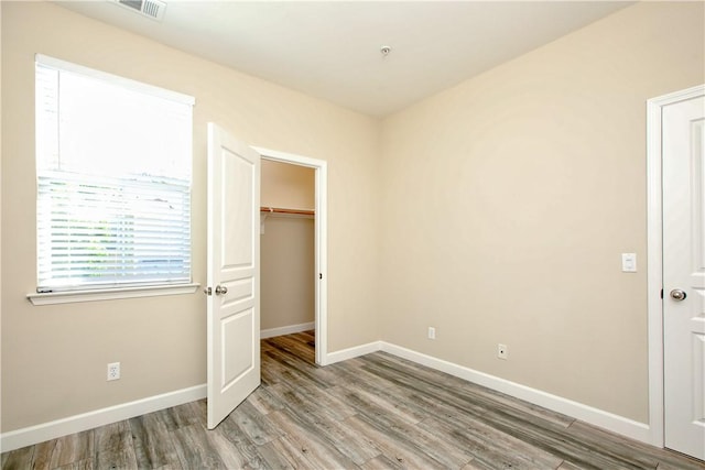 3591 Sacramento Dr Unit 50, San Luis Obispo, CA 93401 - unfurnished bedroom with light wood-type flooring, a spacious closet, and a closet